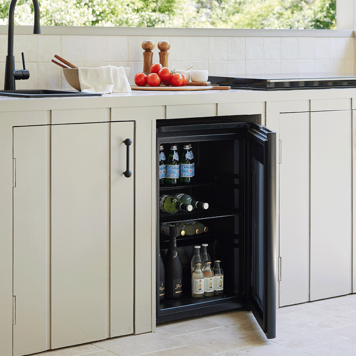 Artusi ABC1B bar fridge lifestyle - door open and stocked with bottles