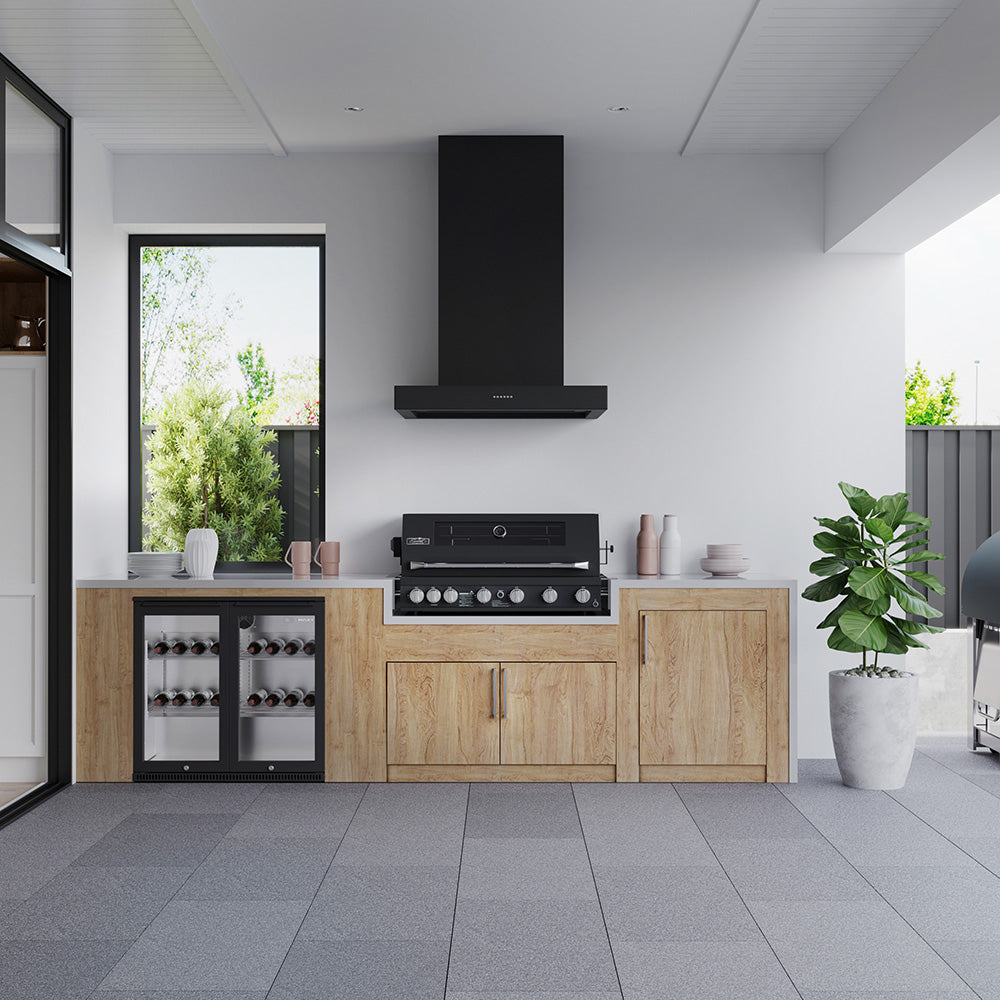 Smart black built-in gas BBQ under a black rangehood in an enclosed alfresco kitchen with timber cabinetry and a wine fridge