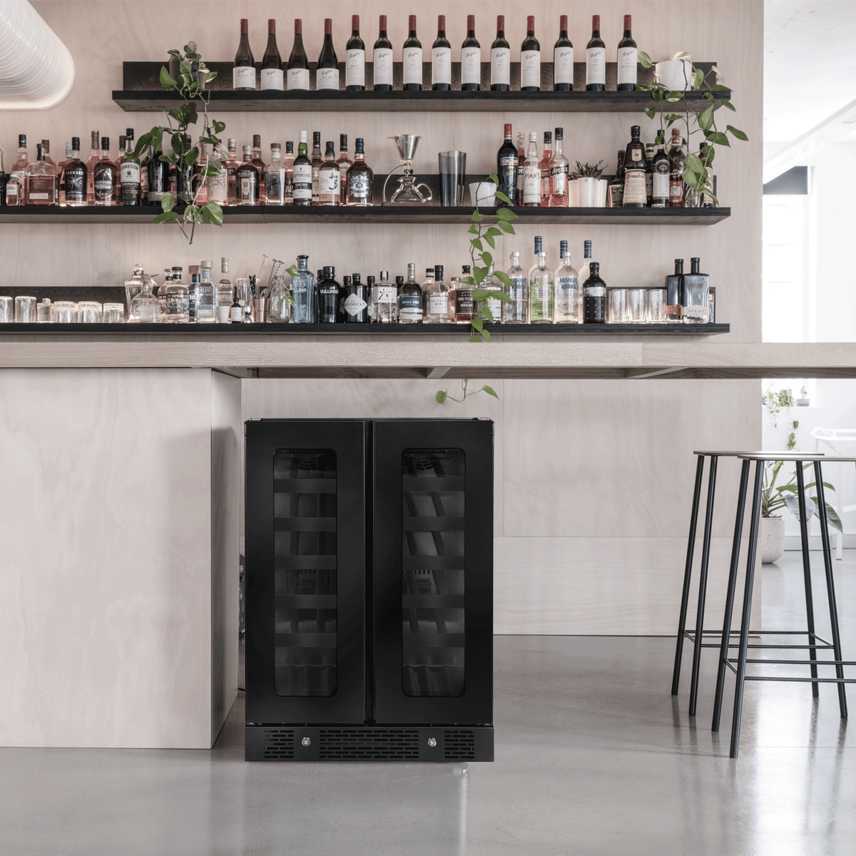 Artusi AWC36BV black double door wine cellar installed below a bar shelf of bottles