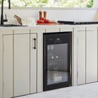 Artusi ABC1B bar fridge lifestyle - glass door fridge set into kitchen cabinetry
