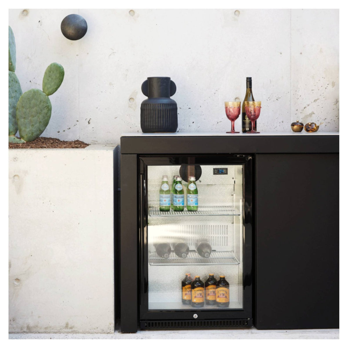 Artusi outdoor beverage chiller stocked with drinks and styled with decor