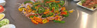 Vegetables cooking on a Cook N Dine UltraDine teppanyaki grill
