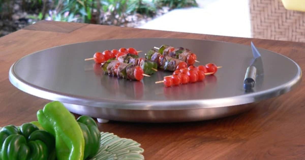 Cook N Dine UltraDine portable teppanyaki grill cooking kebabs on the stainless steel surface