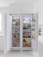 Kleenmaid CR30911 and CZ21911 fully integrated refrigerator and freezer in a white kitchen with food