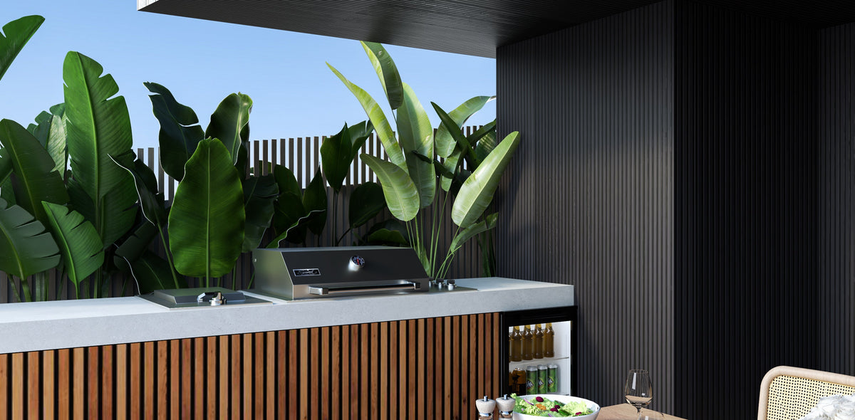 Smart drop-in gas BBQ in an outdoor kitchen with timber and stone benchtop