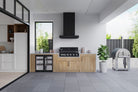 Smart 601WB black built-in gas BBQ in a modern outdoor kitchen with rangehood and pizza oven