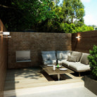Smart WM700EW wall mounted electric BBQ folded away on a brick wall in a courtyard seating area