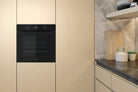 Whirlpool W4OMK581HU1BAUS black built-in oven installed in a kitchen